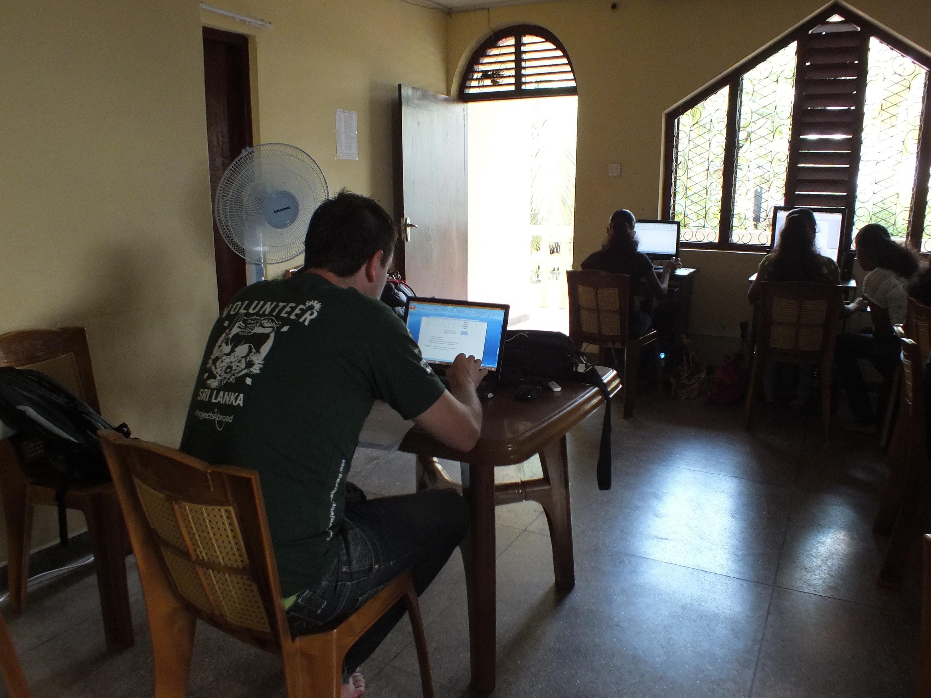 A Projects Abroad business intern in Sri Lanka trains a group of locals on CV making At his placement, an intern gains business work experience during training sessions.